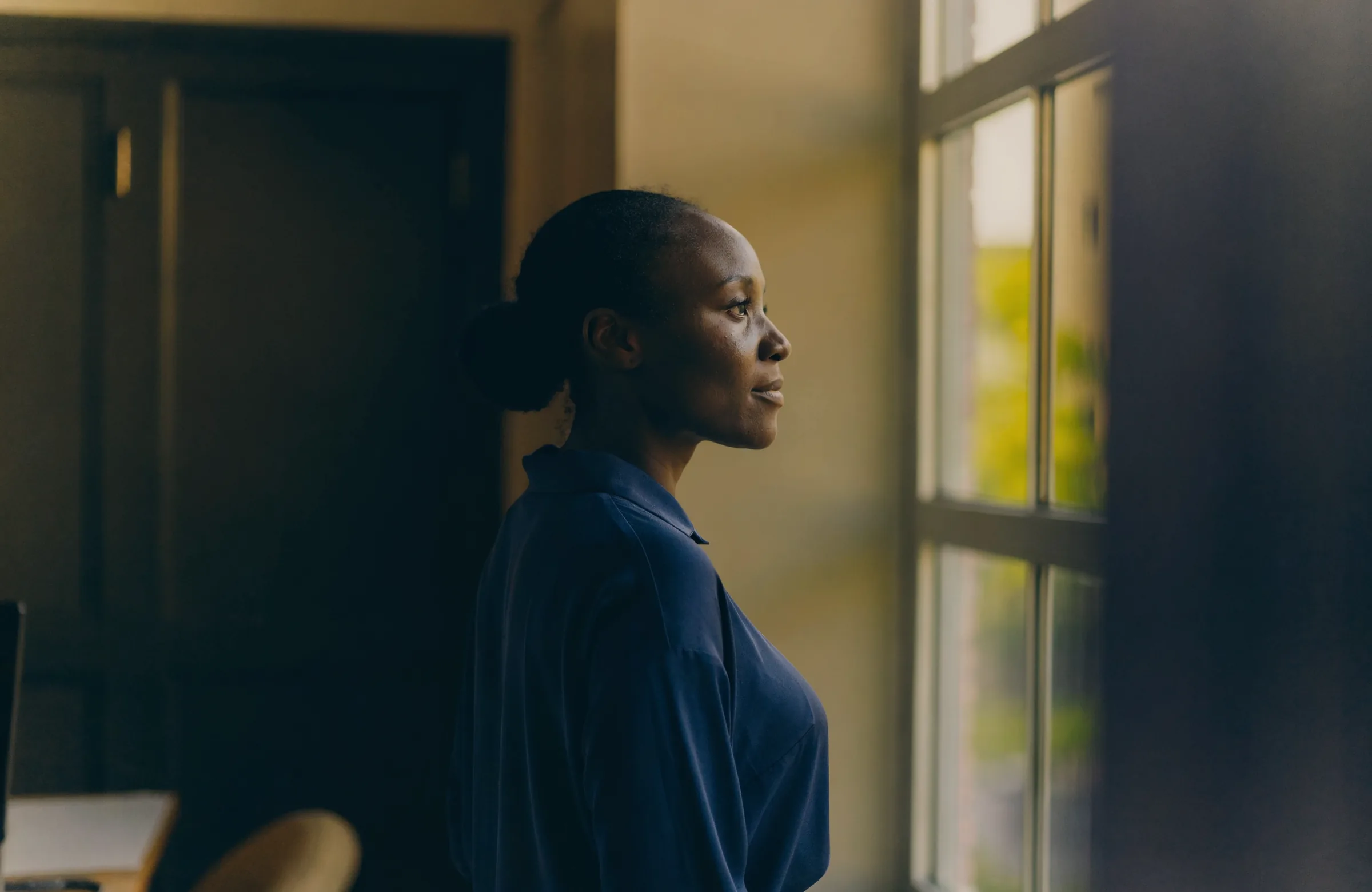 An ICB customer at the window of her office in Accra, early morning.